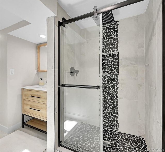 bathroom with vanity and a shower with door