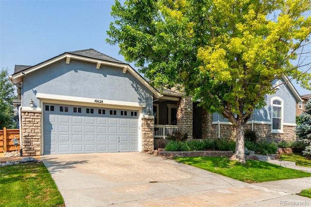 view of front of property with a front yard and a garage