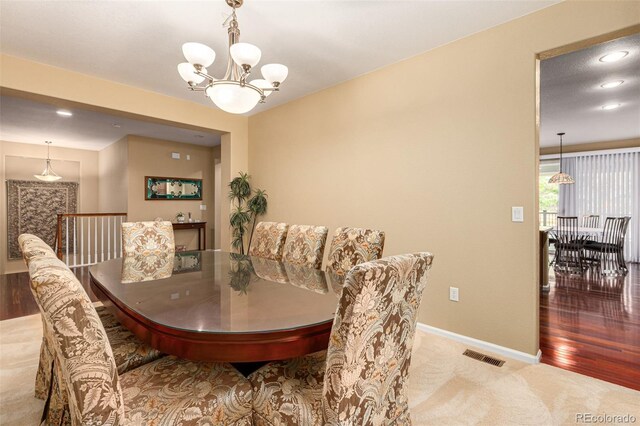 dining room featuring wood-type flooring and a notable chandelier