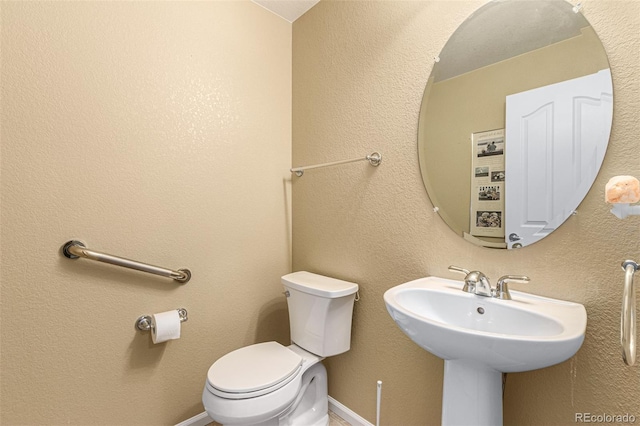 bathroom featuring sink and toilet