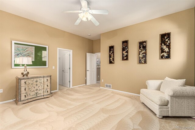 living area with ceiling fan and carpet