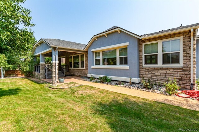 back of house featuring a yard