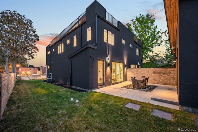 4227 Mariposa St, Denver, CO 80211 - back of property at dusk featuring a patio, stucco siding, and central AC unit