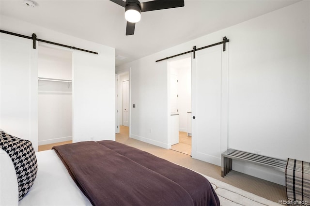 4227 Mariposa St, Denver, CO 80211 - bedroom with a barn door, light carpet, baseboards, ceiling fan, and a closet