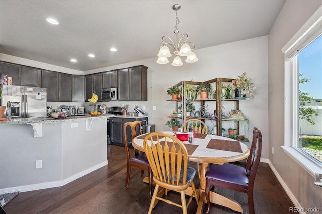 2431 Nicholson St, Berthoud, CO 80513 - dining space featuring dark wood-style floors, a chandelier, recessed lighting, and baseboards