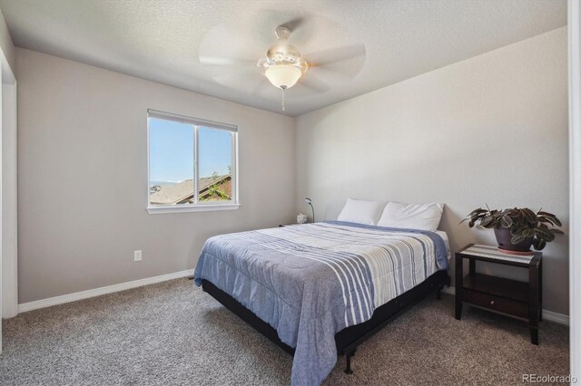 2431 Nicholson St, Berthoud, CO 80513 - carpeted bedroom with baseboards, a textured ceiling, and ceiling fan