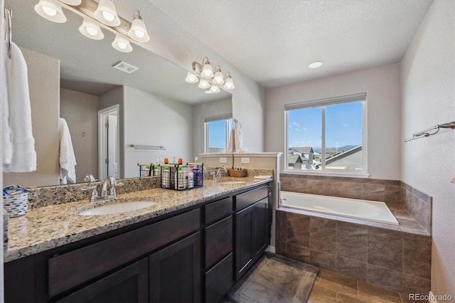 2431 Nicholson St, Berthoud, CO 80513 - bathroom featuring double vanity, a garden tub, and tile patterned flooring