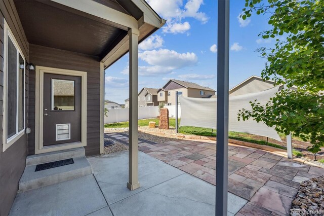 2431 Nicholson St, Berthoud, CO 80513 - view of patio / terrace with fence and a residential view
