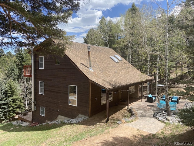 11724 Little Turtle Ln, Conifer, CO 80433 - view of property exterior with roof with shingles and a patio