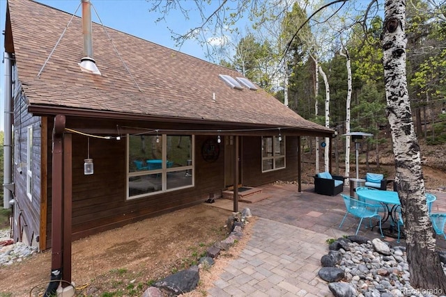 11724 Little Turtle Ln, Conifer, CO 80433 - back of house with a patio and a shingled roof