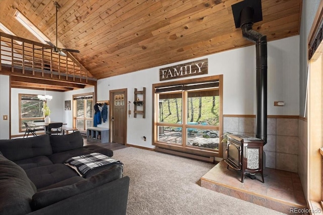 11724 Little Turtle Ln, Conifer, CO 80433 - living room with a wood stove, wooden ceiling, carpet floors, a ceiling fan, and baseboard heating