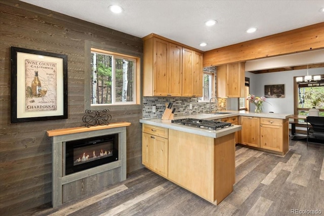 11724 Little Turtle Ln, Conifer, CO 80433 - kitchen with a peninsula, a sink, stainless steel gas cooktop, dark wood-style flooring, and recessed lighting