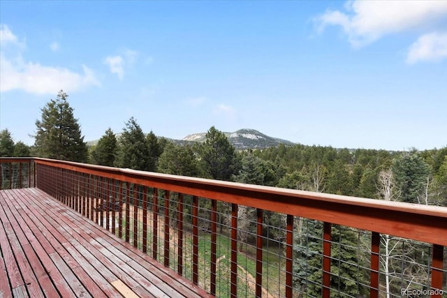 11724 Little Turtle Ln, Conifer, CO 80433 - wooden deck featuring a view of trees