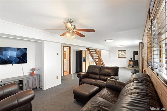 11724 Little Turtle Ln, Conifer, CO 80433 - carpeted living area featuring a wood stove, ceiling fan, and stairway