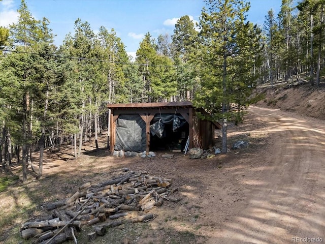 11724 Little Turtle Ln, Conifer, CO 80433 - view of outbuilding with an outbuilding and a wooded view