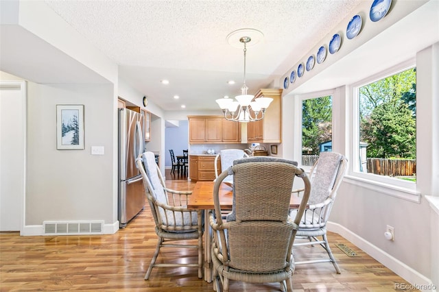 7970 S Cook Way, Centennial, CO 80122 - dining area with baseboards, light wood-type flooring, a chandelier, a textured ceiling, and recessed lighting