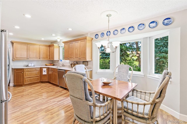 7970 S Cook Way, Centennial, CO 80122 - dining space with light wood-type flooring, recessed lighting, a chandelier, a textured ceiling, and baseboards