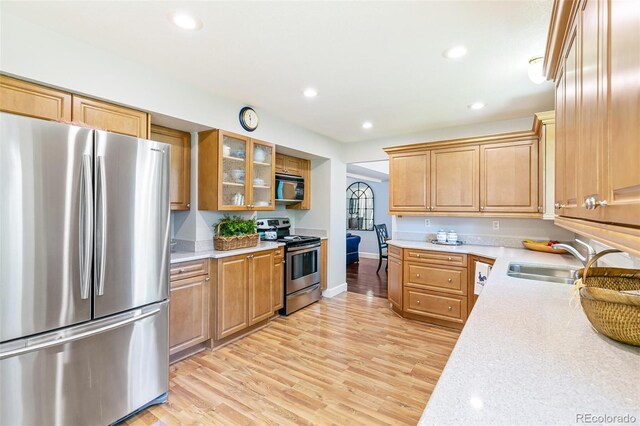 7970 S Cook Way, Centennial, CO 80122 - kitchen featuring appliances with stainless steel finishes, a sink, light wood-style flooring, glass insert cabinets, and recessed lighting