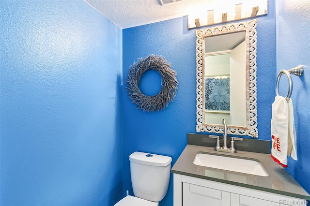 7970 S Cook Way, Centennial, CO 80122 - bathroom featuring toilet, a textured ceiling, a textured wall, and vanity