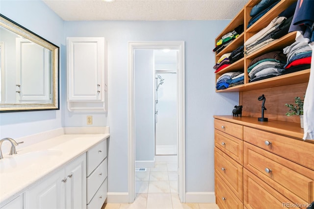 7970 S Cook Way, Centennial, CO 80122 - bathroom featuring vanity, a textured ceiling, and baseboards