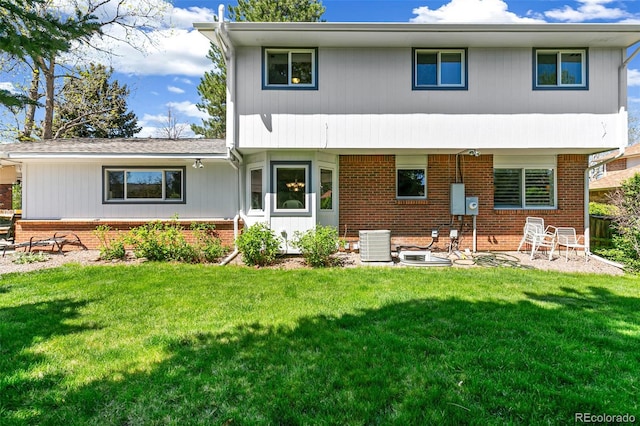 7970 S Cook Way, Centennial, CO 80122 - rear view of house featuring central air condition unit, brick siding, and a lawn