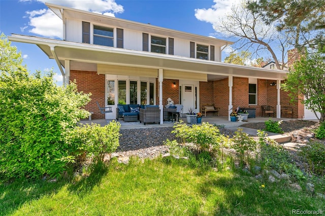 7970 S Cook Way, Centennial, CO 80122 - back of property with brick siding, an outdoor living space, and a patio area