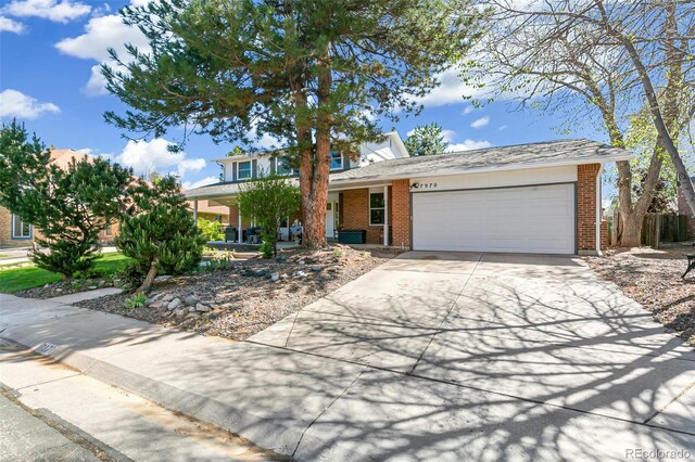 7970 S Cook Way, Centennial, CO 80122 - view of front of property with brick siding, an attached garage, driveway, and a porch