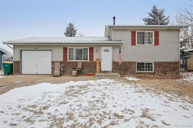 split level home with brick siding and an attached garage