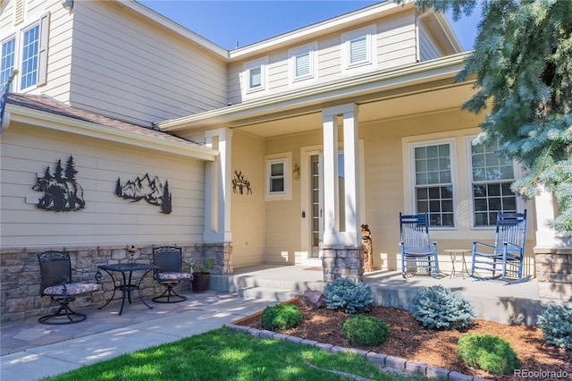 entrance to property featuring a porch