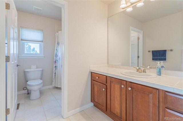 bathroom with vanity, tile patterned floors, and toilet