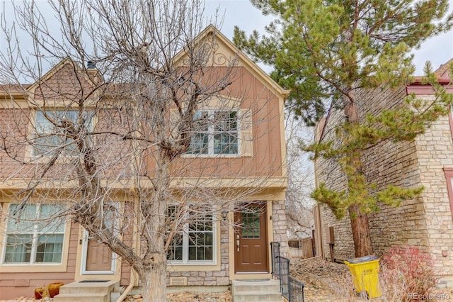 view of front facade featuring stone siding and entry steps