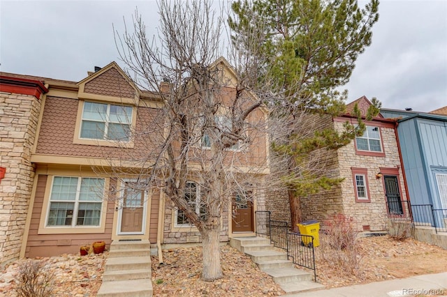 view of property featuring stone siding and entry steps