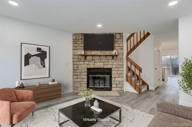 11973 E Kepner Dr, Aurora, CO 80012 - living area featuring wood finished floors, stairway, recessed lighting, baseboards, and a large fireplace