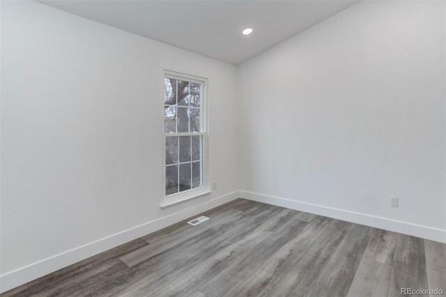 11973 E Kepner Dr, Aurora, CO 80012 - unfurnished room with baseboards, wood finished floors, and recessed lighting