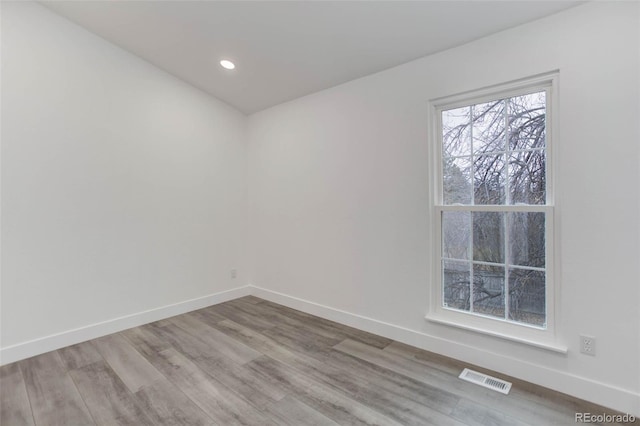 11973 E Kepner Dr, Aurora, CO 80012 - spare room with wood finished floors, baseboards, and recessed lighting