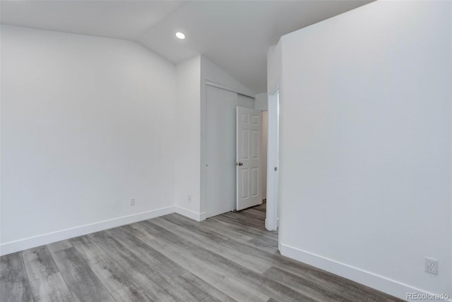 11973 E Kepner Dr, Aurora, CO 80012 - unfurnished room with lofted ceiling, wood finished floors, baseboards, and recessed lighting