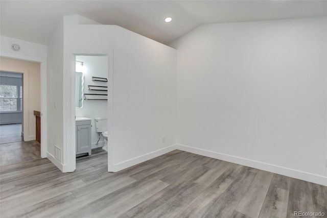 11973 E Kepner Dr, Aurora, CO 80012 - spare room with light wood-style flooring, vaulted ceiling, baseboards, and recessed lighting