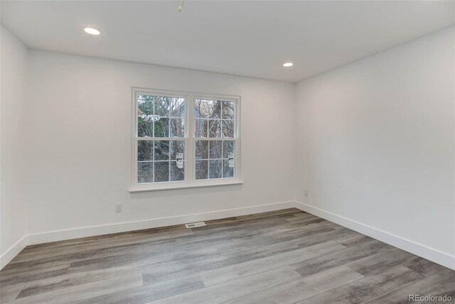 11973 E Kepner Dr, Aurora, CO 80012 - empty room featuring wood finished floors, baseboards, and recessed lighting