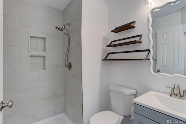 11973 E Kepner Dr, Aurora, CO 80012 - bathroom with vanity, toilet, and a tile shower