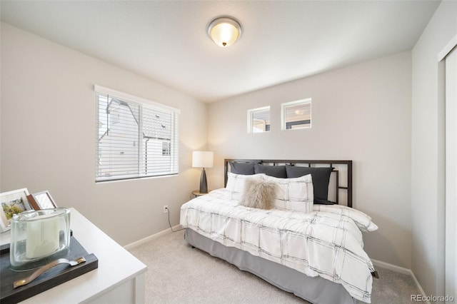 carpeted bedroom featuring multiple windows