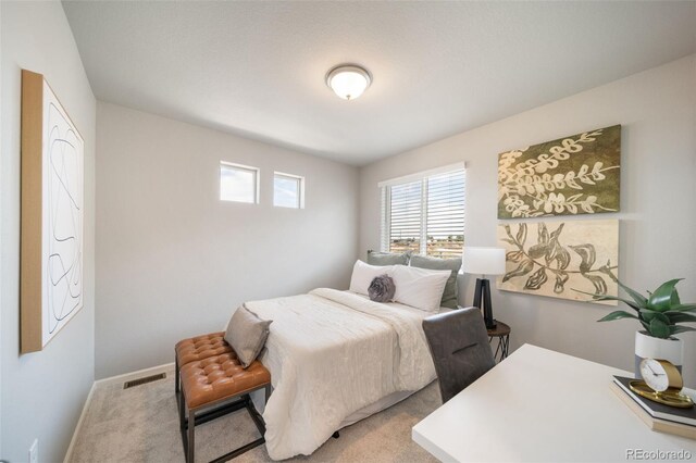 bedroom featuring light colored carpet