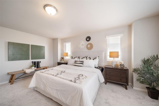 bedroom featuring multiple windows and light carpet