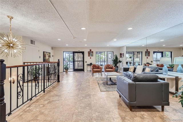 living room with a notable chandelier and a textured ceiling