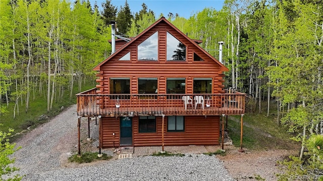 760 Coyote Cir, Black Hawk, CO 80422 - rear view of property featuring a wooden deck, driveway, and log siding