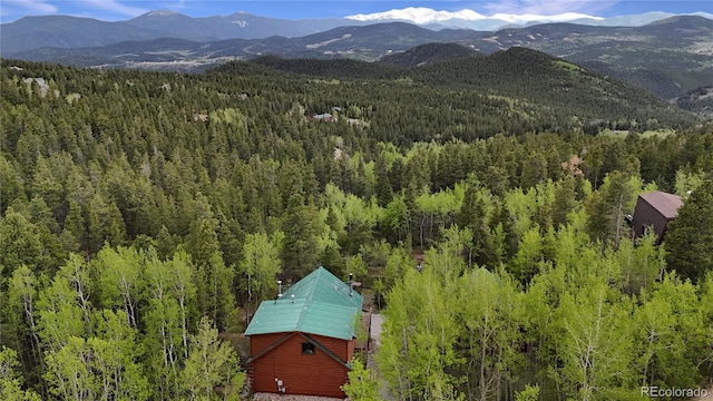 760 Coyote Cir, Black Hawk, CO 80422 - drone / aerial view of a heavily wooded area and a mountain backdrop