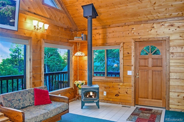 760 Coyote Cir, Black Hawk, CO 80422 - foyer featuring a wood stove, wooden ceiling, wooden walls, lofted ceiling, and light tile patterned floors