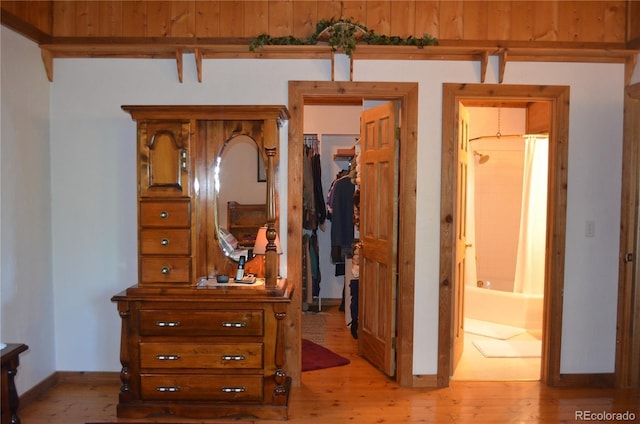 760 Coyote Cir, Black Hawk, CO 80422 - bedroom featuring light wood finished floors, a spacious closet, baseboards, and a closet