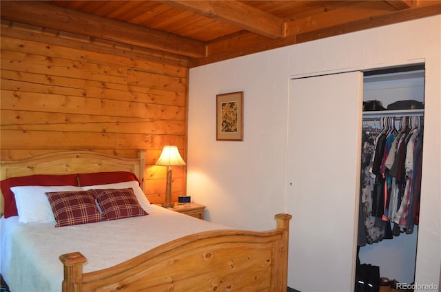 760 Coyote Cir, Black Hawk, CO 80422 - bedroom with wood ceiling, beam ceiling, a closet, and wooden walls