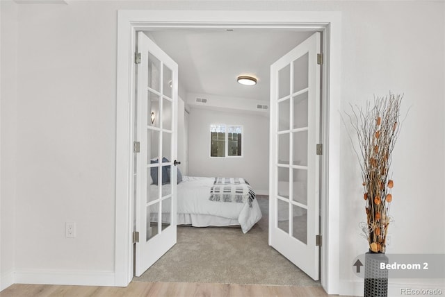 interior space with light carpet and french doors