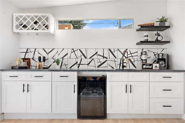 bar featuring backsplash, plenty of natural light, and beverage cooler